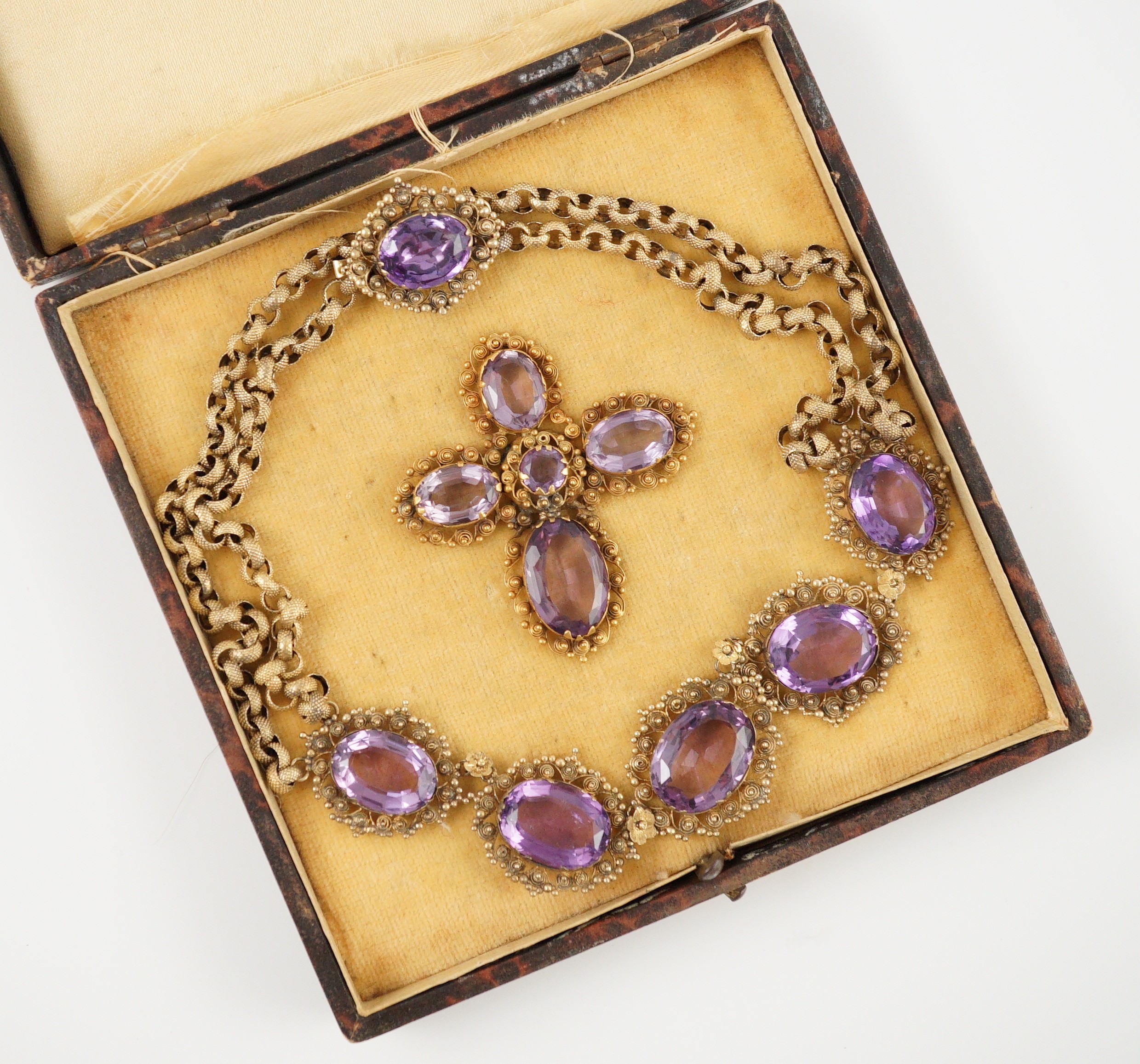 An early 19th century gold and eleven stone oval cut amethyst set pendant necklace and a similar cross pendant (repair)